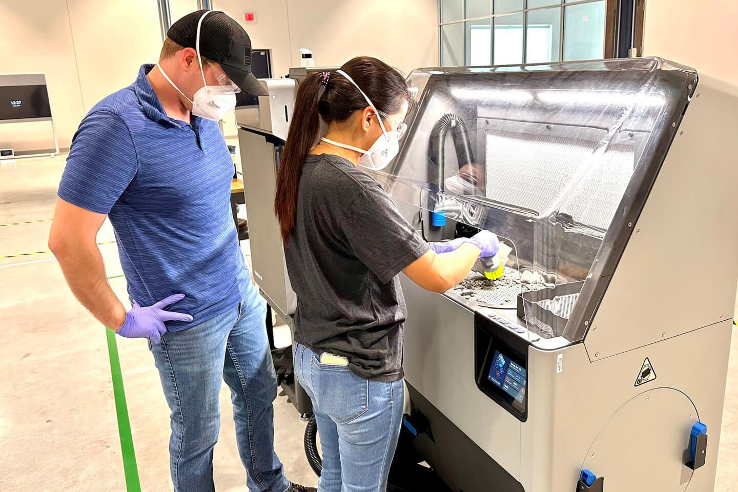 Instructor with female student learning energy manufacturing